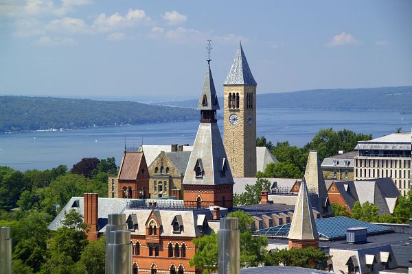A view of Barnes Hall and the Cornell clock tower with Cayuga Lake int he background.