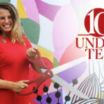 a woman standing in front of a brightly colored background holding a huge pair of scissors cutting a ribbon and smiling. the 10 Under 10 graphic identifier is overlaid on the photo.