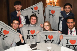 Group of international students holding up "I heart NY" shirts