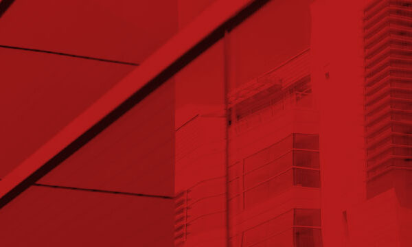 Photo of glass window with a building reflecting in it