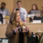 Professor Risa Mish teaches in a classroom with tiered seating.