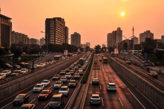 cityscape of cars on highway during sunset