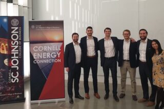 Members of the Cornell Energy Club Board next to Cornell Energy Connection banners