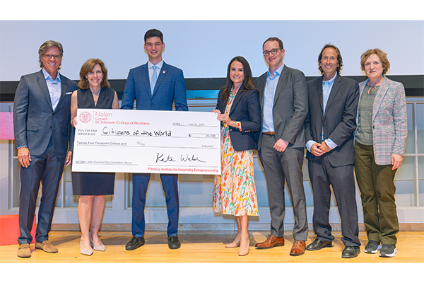 Lucas Suero with big check. Also pictured are judges Zach Demuth, Chris Hemmeter, Gilda Perez-Alvarado, Dean Kate Walsh, David Sherwyn and Linda Canina