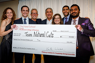 Team holding a large check at BPC 2017