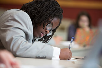 Student writing on a piece of paper