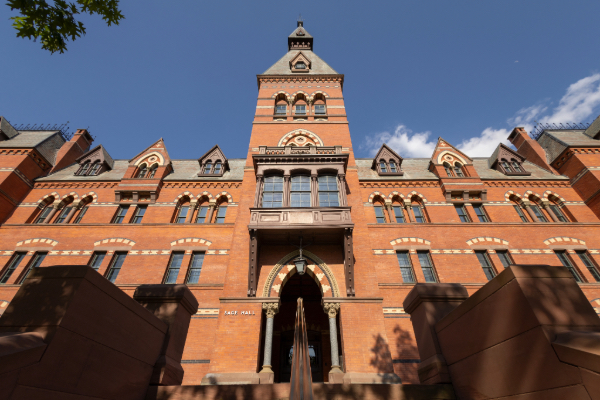 A view of Sage Hall looking up toward the sky.