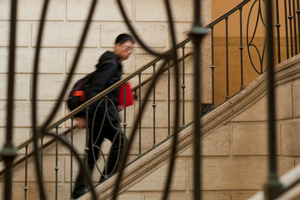 A student walks up a staircase.