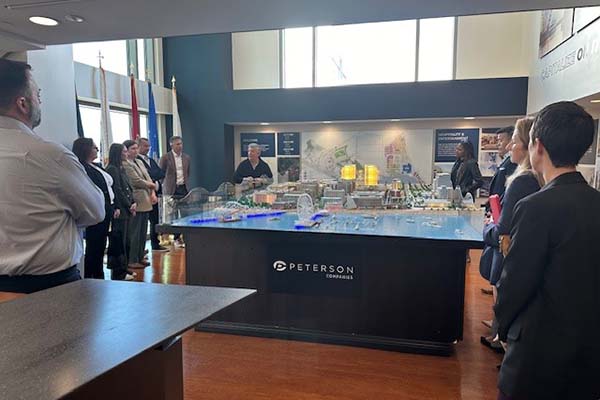 Participants gather around National Harbor architectural model to learn more about project developments