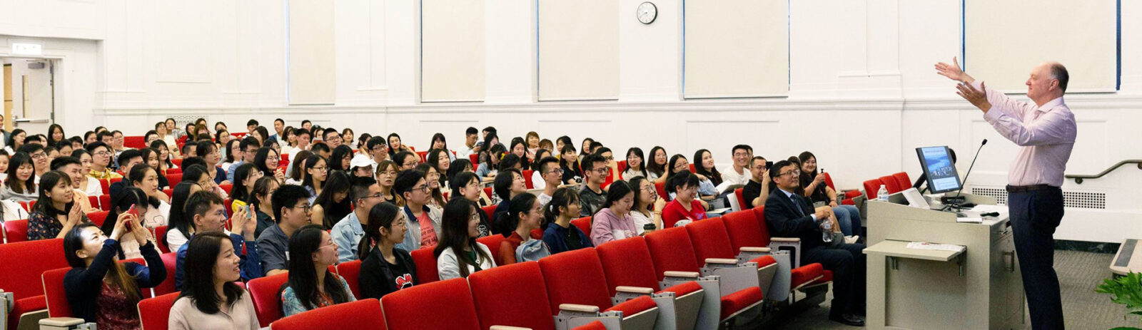 Andrew Karoyli lecturing students in a classroom in Warren Hall.