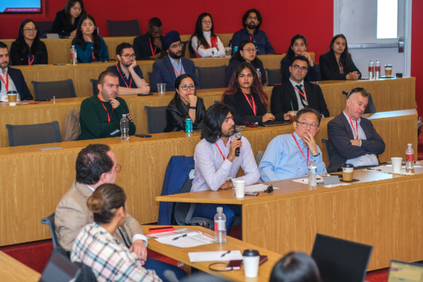 Audience and judges of the competition seated in a classroom during the final presentations.