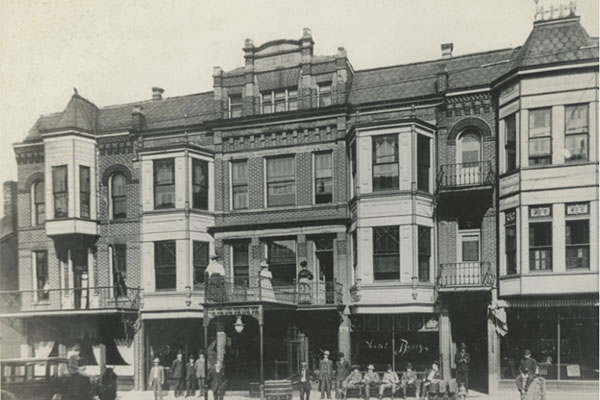 black and white photo of an ornate, 3-story building.