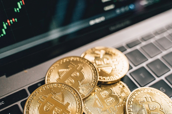 Illustrative coins shaped by Bitcoin’s symbol on a laptop used for investments.