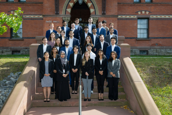 Image of Courtney Huang and fellow Cayuga Fund members on the outside stairs of Sage Hall
