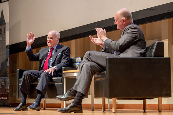 Image of Henry Kravis and Andrew Karolyi on stage during the lecture.
