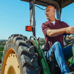 Image of a male farmer on a tractor