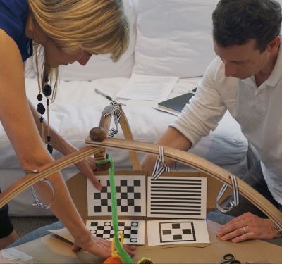 A female and male testing an early prototype of the business’ first product: the Play Gym