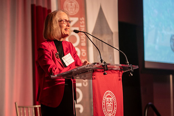 Katherine Ward Feld standing at a podium and speaking into a microphone.