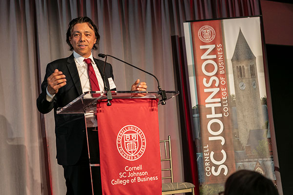 Antonio Alvarez standing at a podium and speaking.