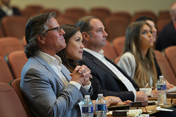 two men and two women sitting side by side in a lecture hall.