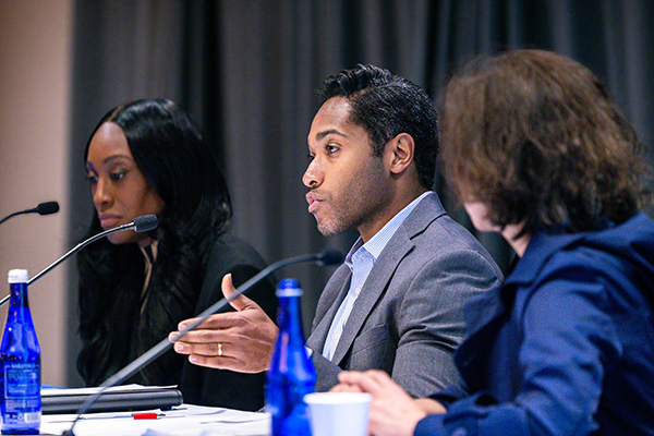 Van Hamilton Barbeau '11, MS/MBA '20 on stage with two panelists speaking