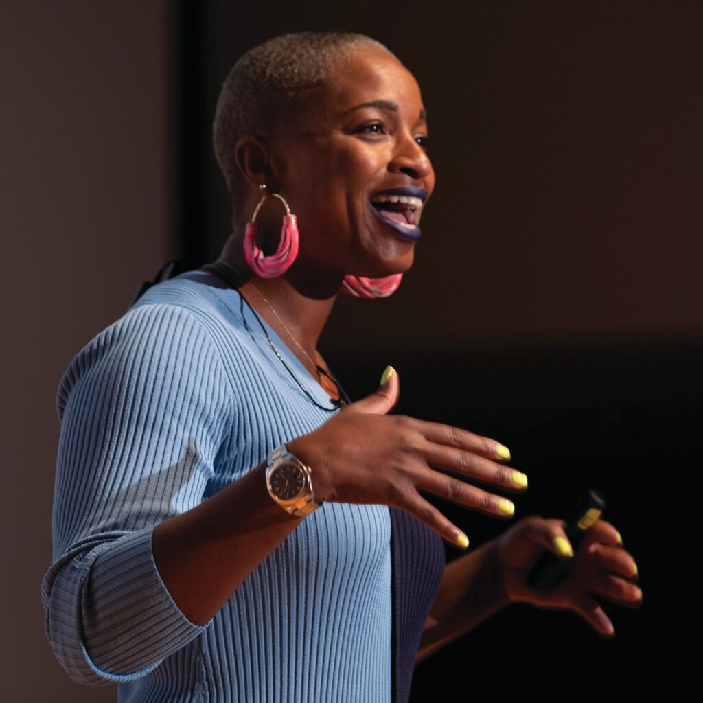 Crystal Vinisse Thomas wears a blue sweater and speaks with her hands.