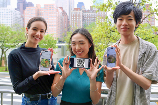 Image of master’s students Alexandra Taic (left), Selina Li and Zach Zhong, all principals of Gymii.ai, a new nutrition tracking app, hold up the app and a recent QR code.