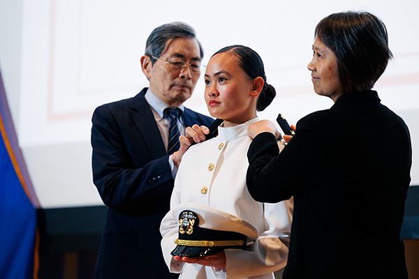 Rose Jou being pinned by her parents at the Cornell University ROTC Tri-Service Commissioning Ceremony, held May 23 in Statler Auditorium.