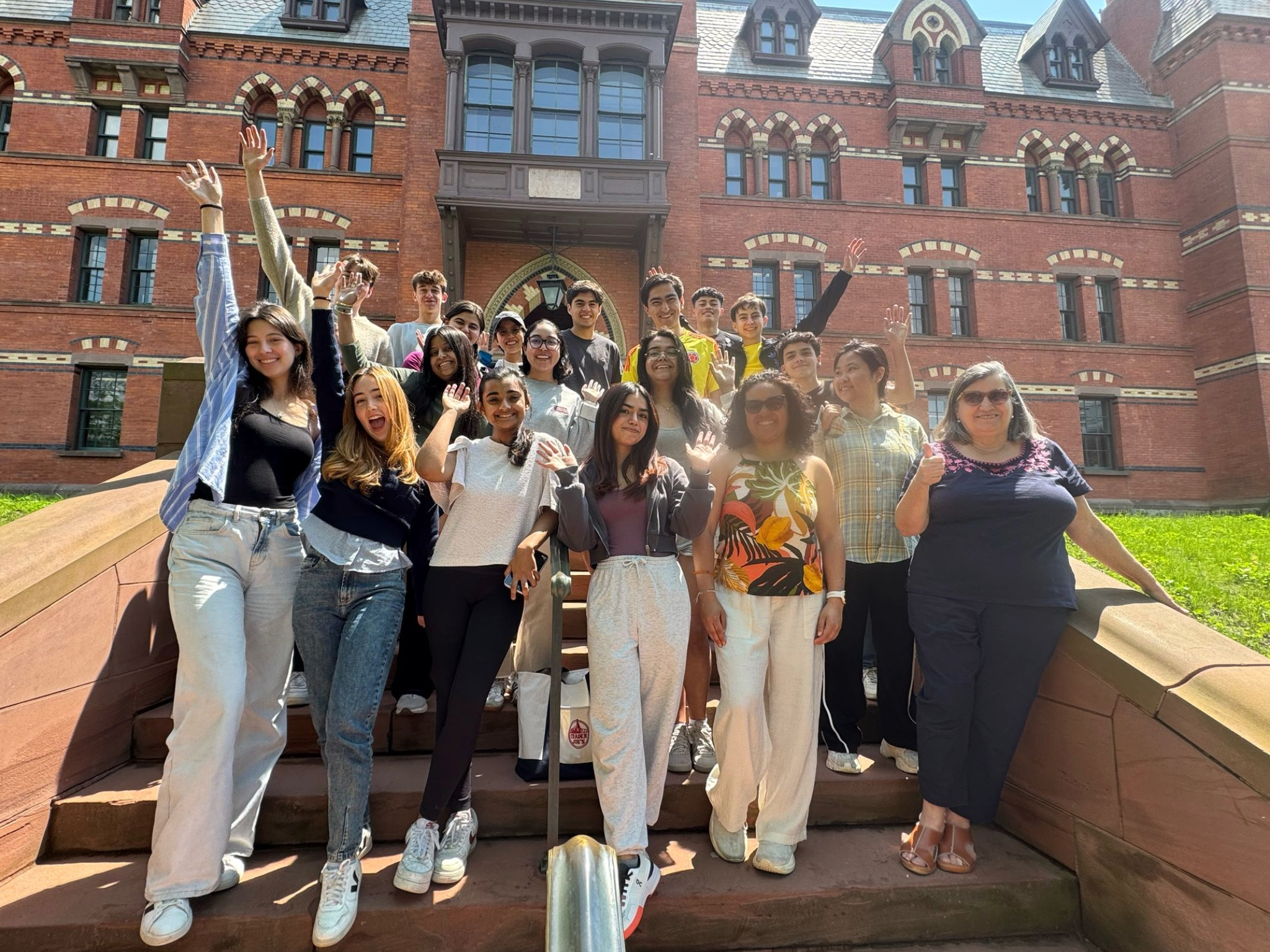 Summer interns outside with the Sage Hall in the background