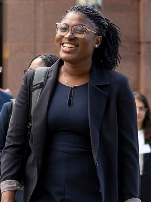 Female MBA Student in front of Sage Hall