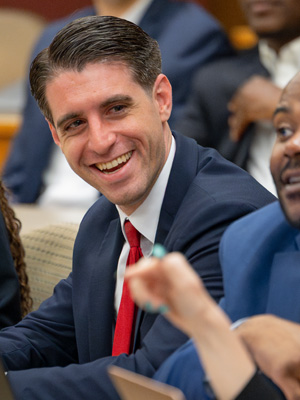 Male MBA student smiling in class, crisis challenge competition