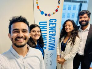 Takwa Elmesawy, MBA '25 and fellow interns standing in front of Generation Unlimited sign, a program Takwa worked on as part of her internship funded by SIIF at UNICEF