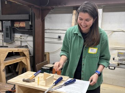 MBA student Jennifer White-Phalen works on a carpentry project using the skills she gained during her visit to Hammerstone.