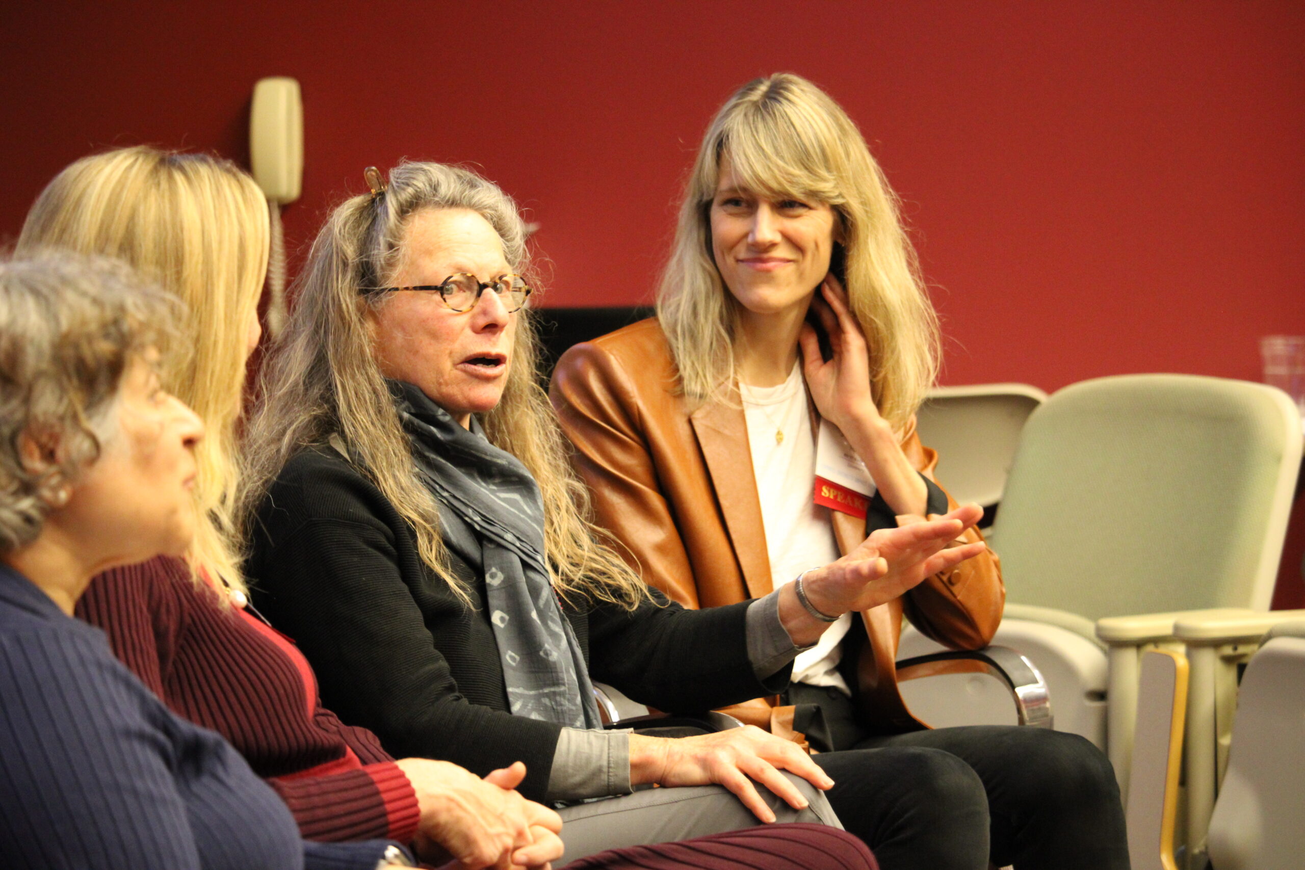 depiction of panelists answering a question from the crowd