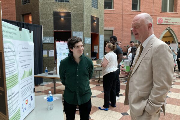 EFII fellow presenting project to Dean Andrew Karolyi
