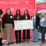 Cornell Business Impact Symposium Investing competition winners being awards prize by judges.