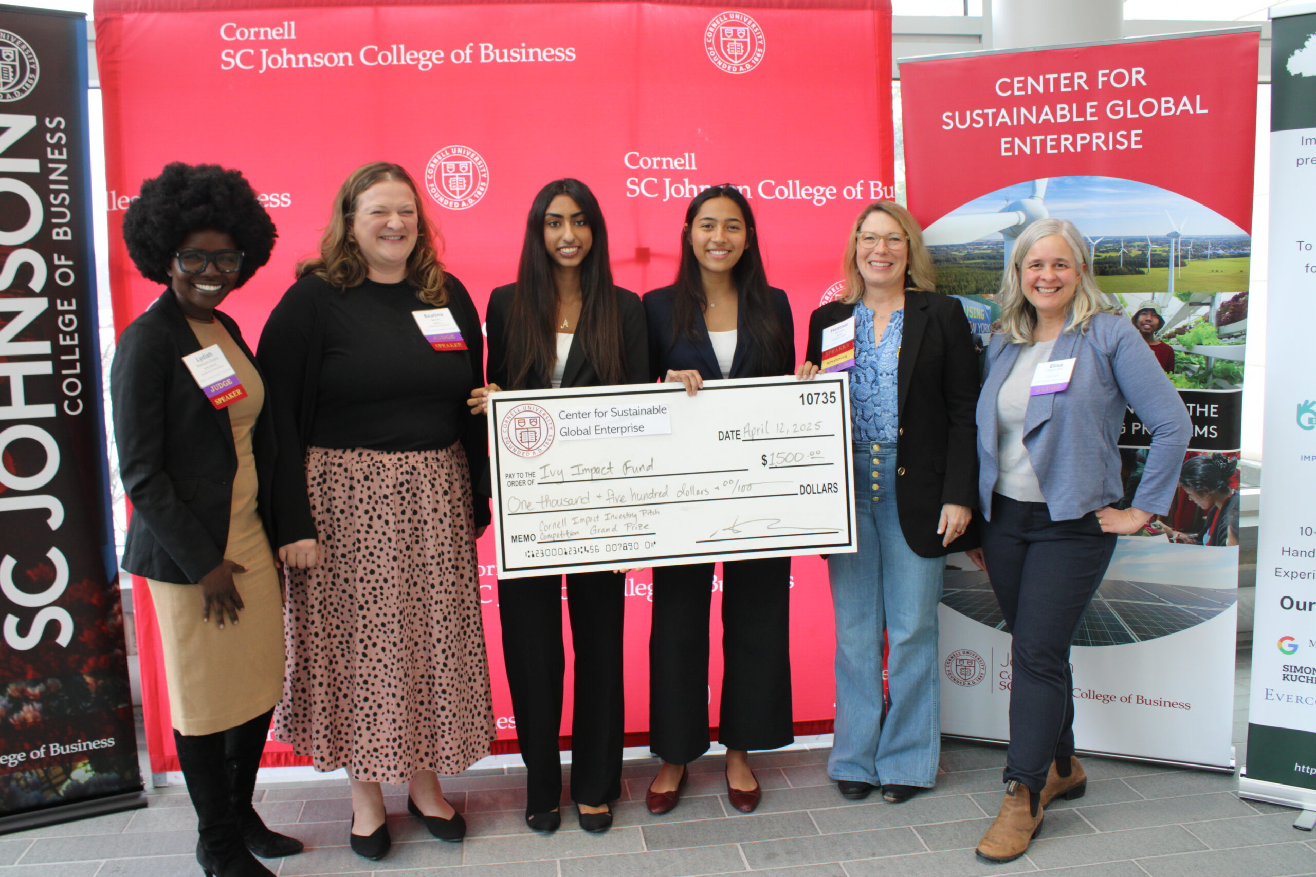 Cornell Business Impact Symposium Investing competition winners being awards prize by judges.