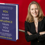 Headshot of Vanessa Bohns, net to an enlarged image of her book, on a red background.