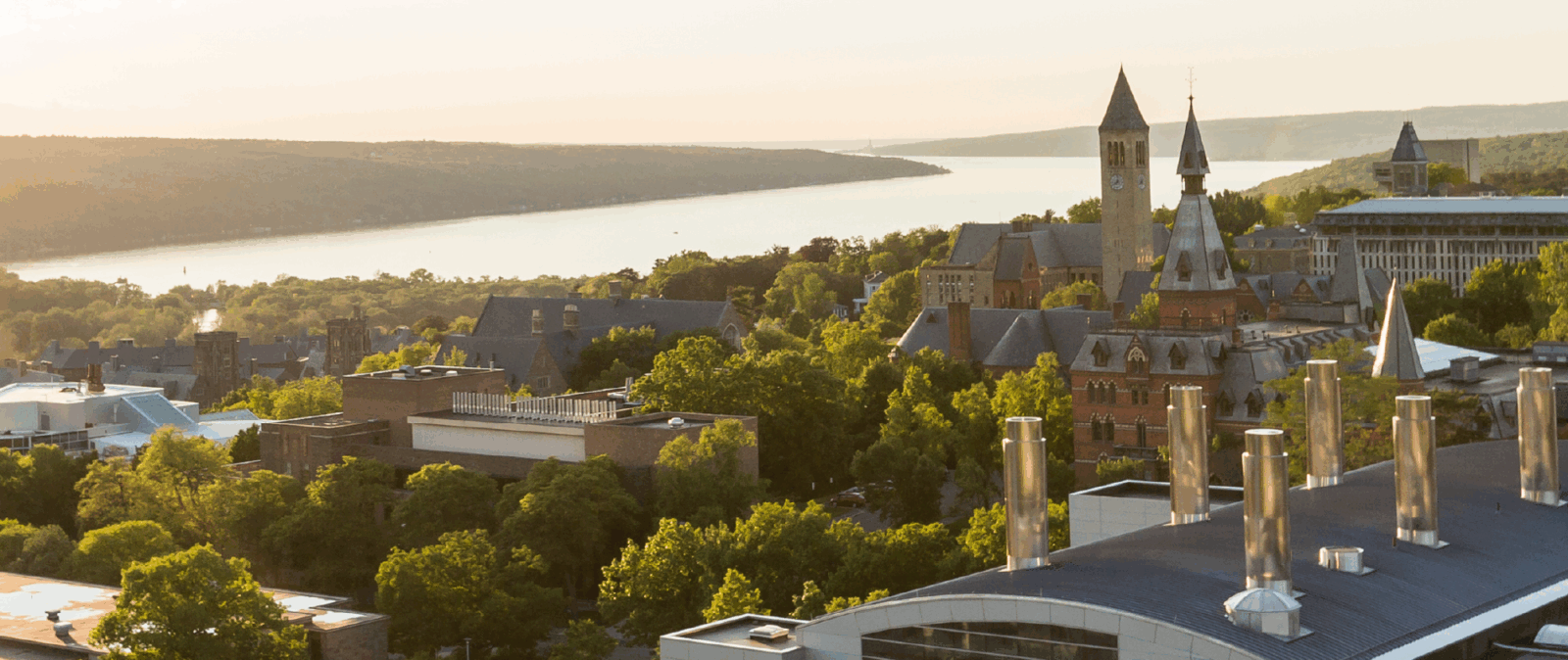 Aerial view of Cornell campus in the summer with Cayuga lake on the horizon.