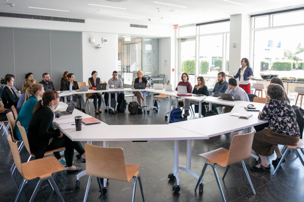 A group of faculty members sitting around a circular table.