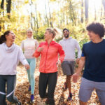 People jogging on a path in the wooods.