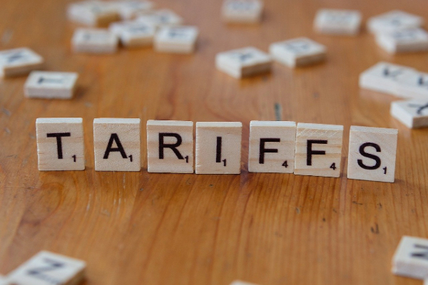 Scrabble tiles that spell the word "tariffs"