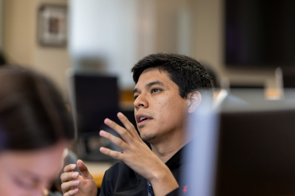Male student speaking in a computer lab