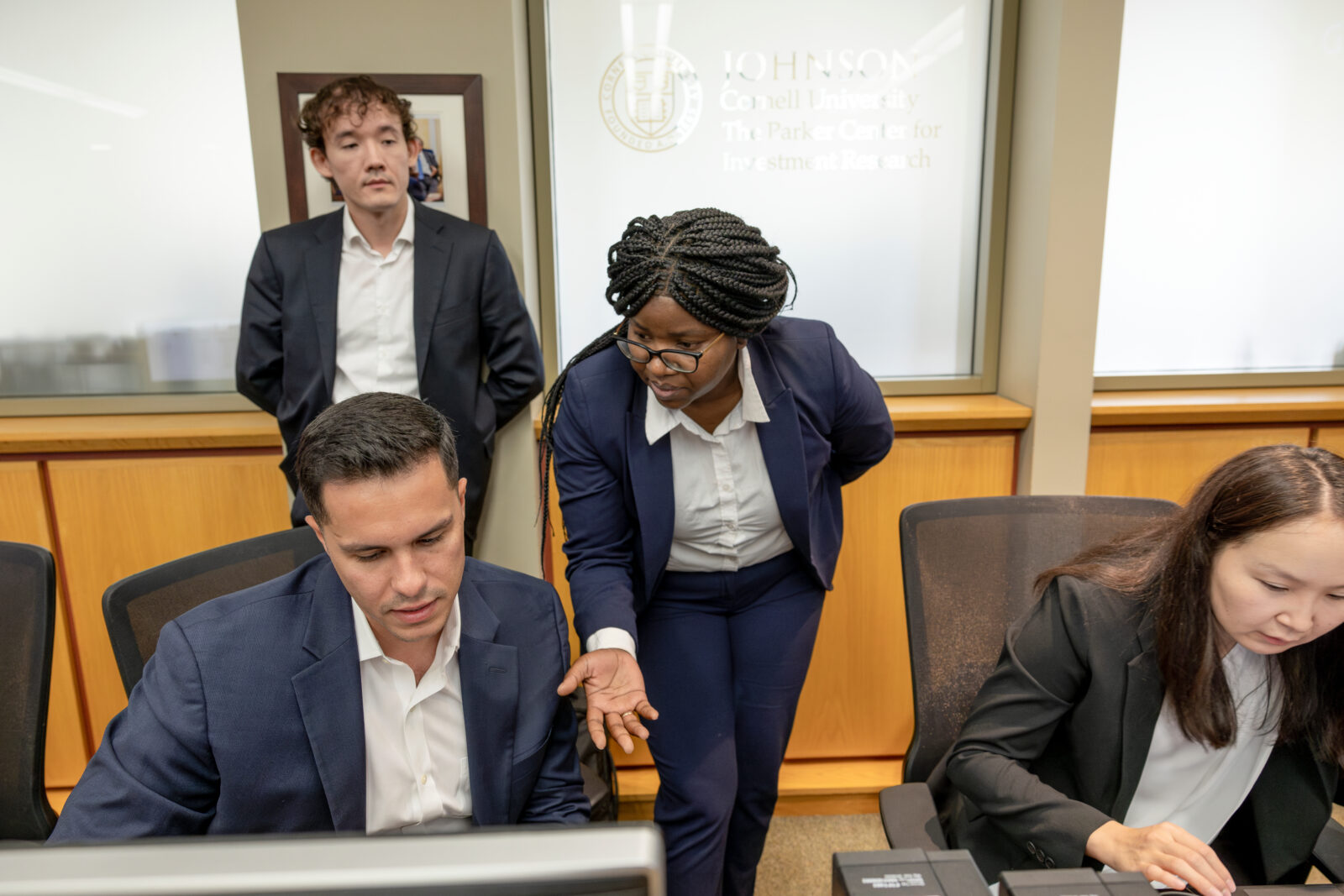 Four students working in a computer lab.