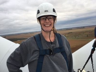 Britta von Oesen standing on top of a wind turbine during a client site visit