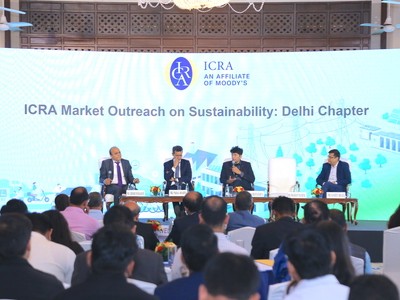 Pinaki Bhattacharyya sitting on stage with a panel in front of a slide stating ICRA Market Outreach on Sustainability.
