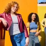 Three women wearing trendy fashions