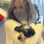 Ava holding her dog at the Naniq offices