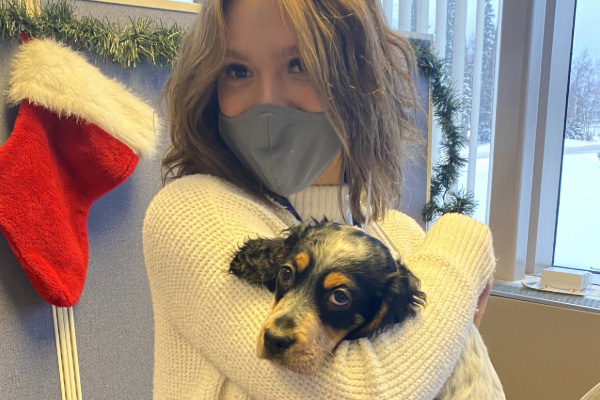 Ava holding her dog at the Naniq offices