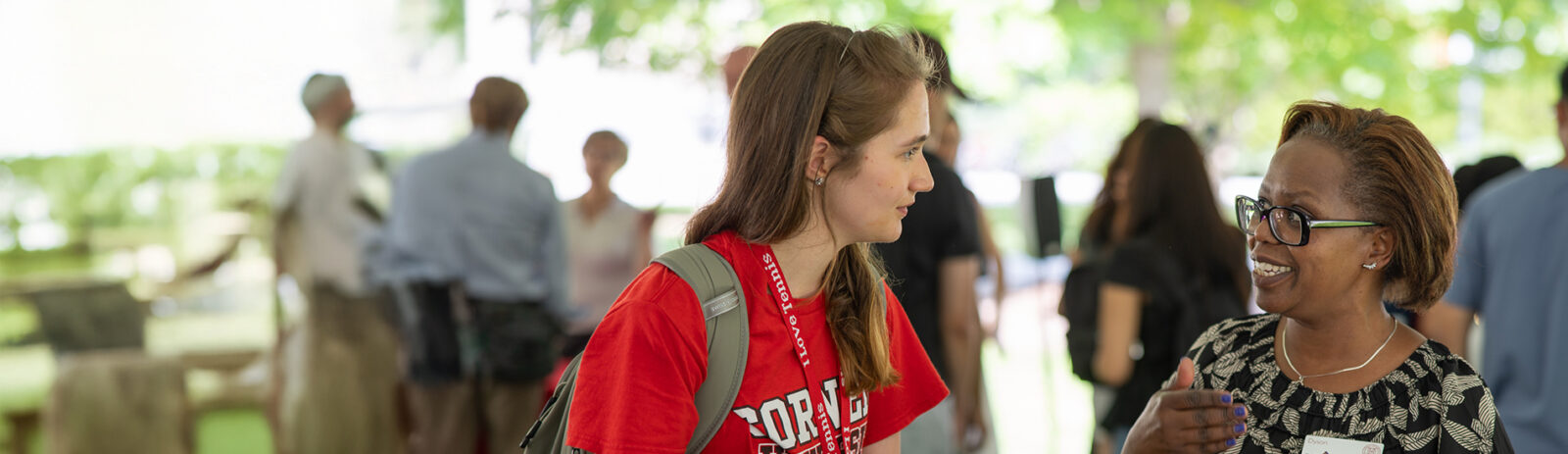 Student talking to faculty member